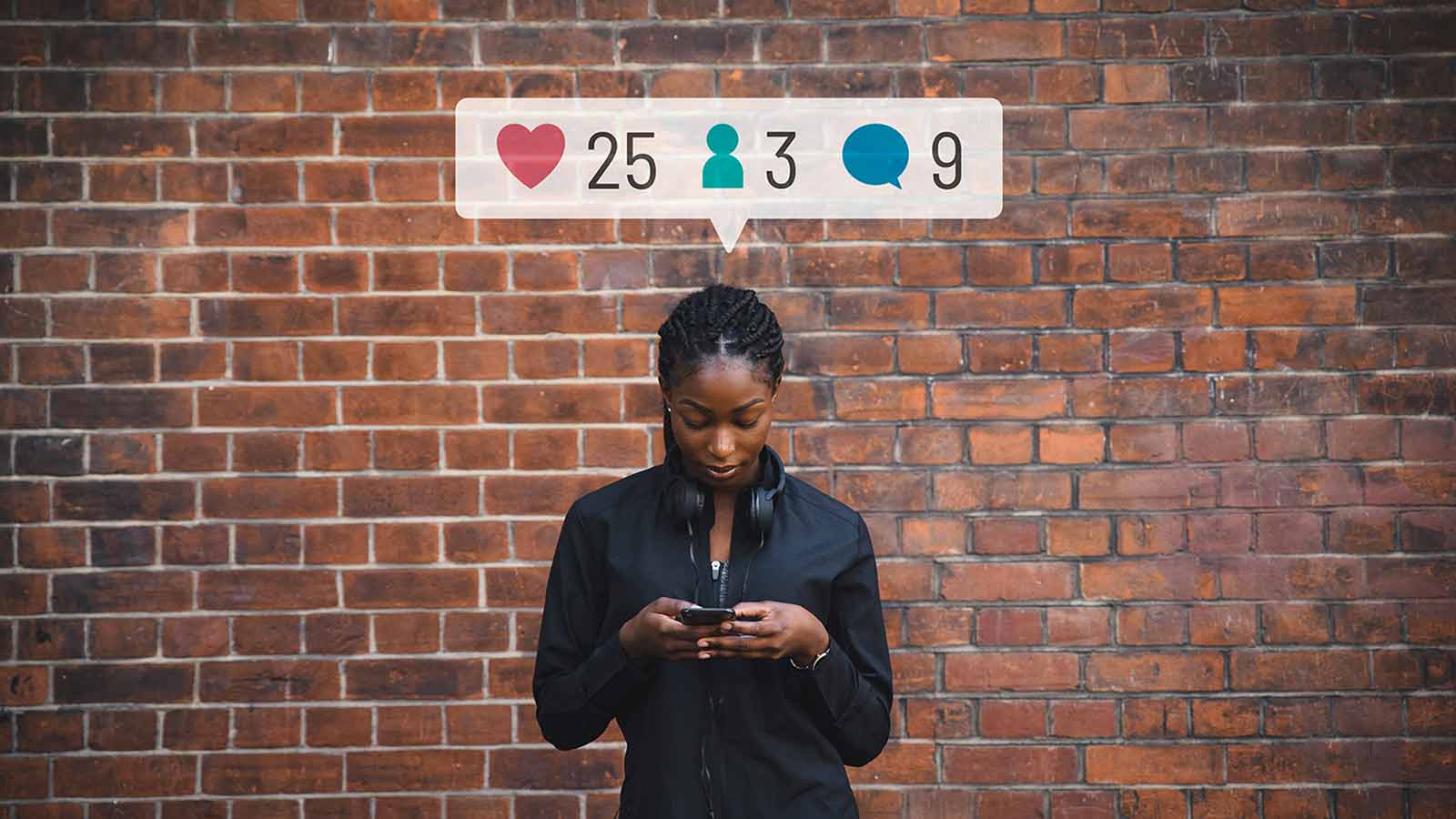 Person looking down at their phone with a brick wall in the background. Above their head are social media icons displaying likes (25), connections (3), and comments (9). Amidst the new NCAA NIL rules, it looks like they're exploring Social Media Influencer Programs to amplify their reach.