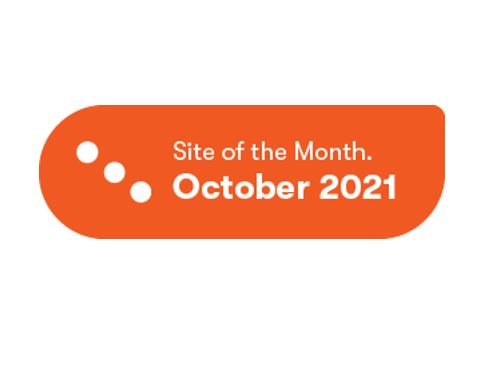 An orange badge displaying "Site of the Month. October 2021" with three white dots on the left, recognized by Falls & Co. for being among the Top Ten Websites using Kentico Xperience.