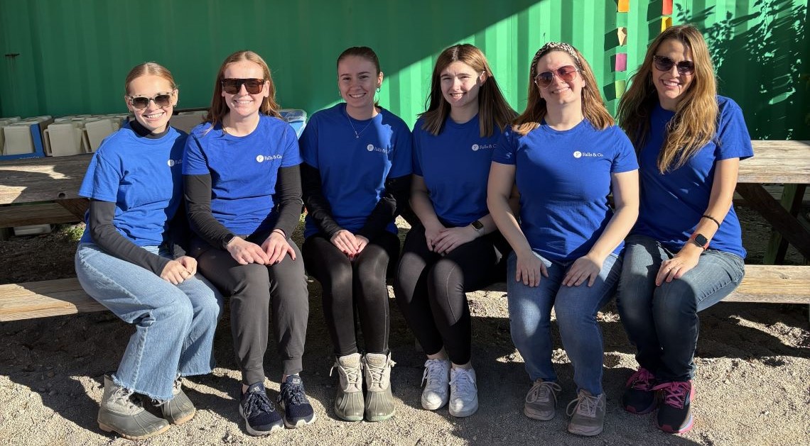 Members of the Falls & Co. Young Professional group wear matching T-shirts on a volunteer day.