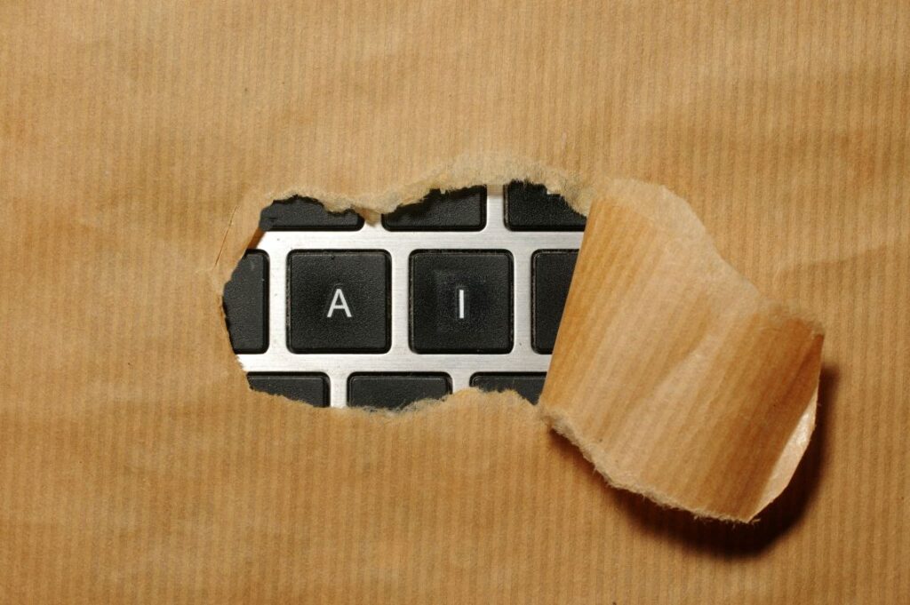 A torn piece of brown paper reveals computer keyboard keys labeled "A" and "I," symbolizing the impact of Generative AI on modern Content Marketing.
